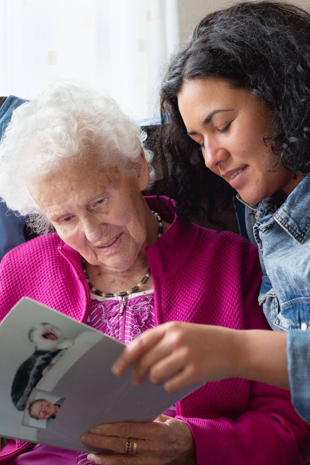 Senior woman with daughter looking at tablet